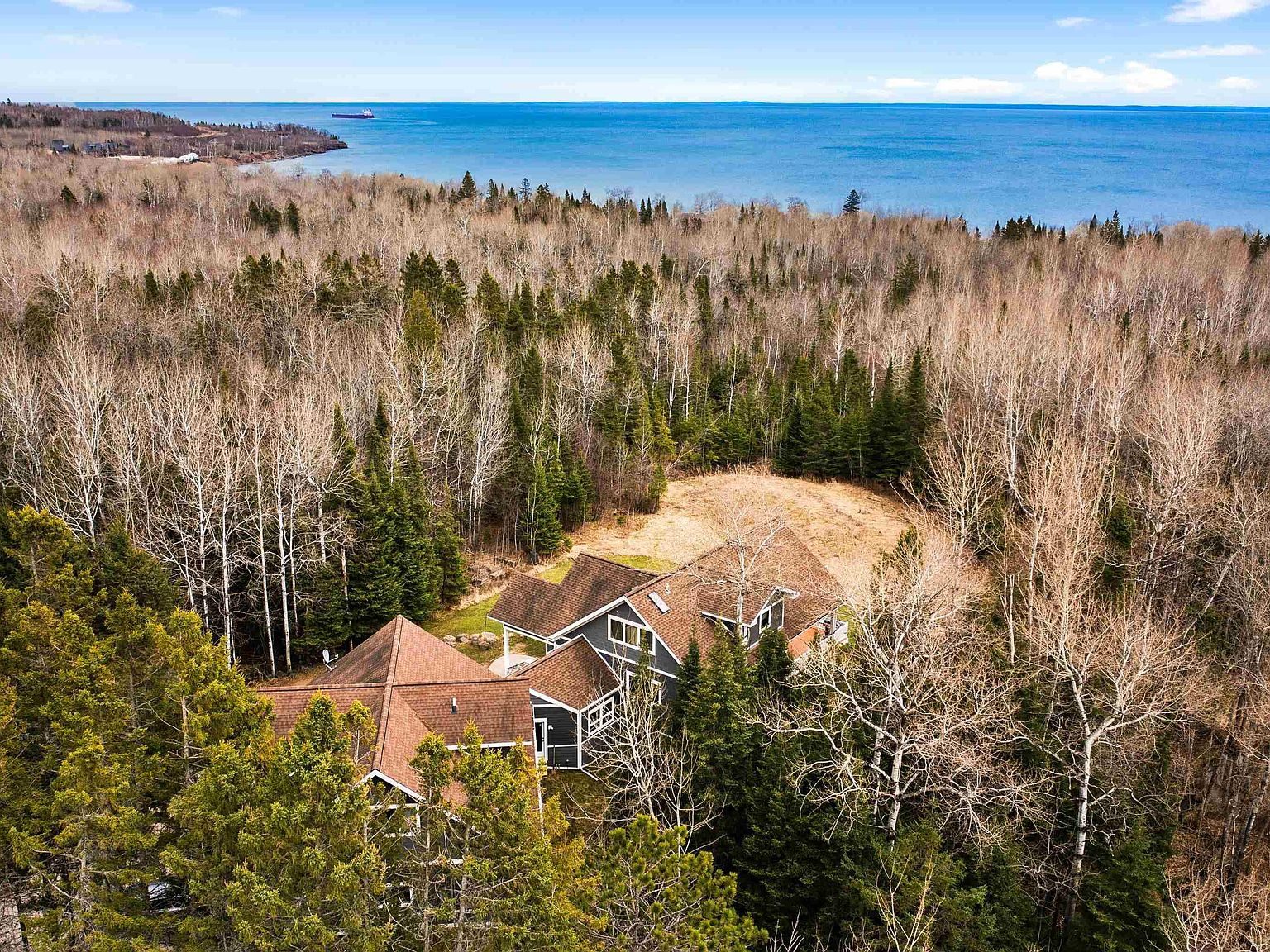 Aerial view over the forested property with Lake Superior stretching to the horizon